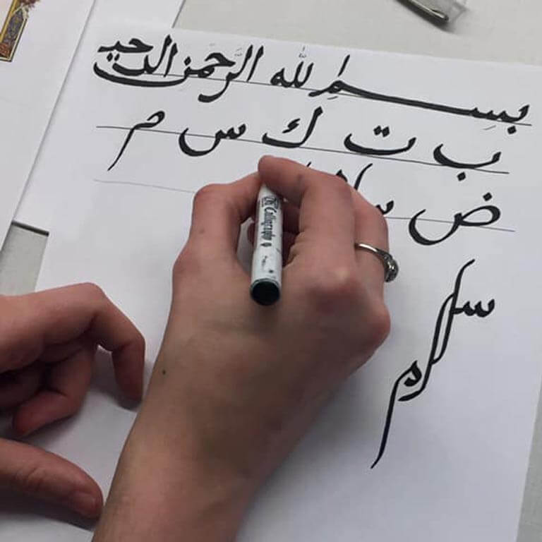hand writing Arabic letters