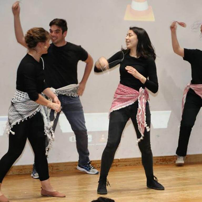 Students dancing in a white room