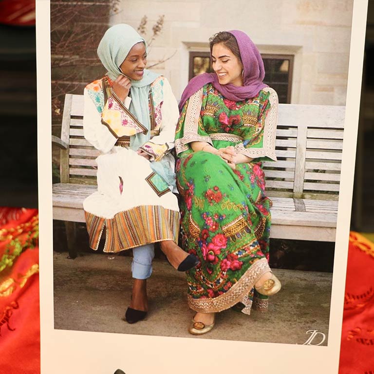 exhibit photo of two Arabic women smiling at each other