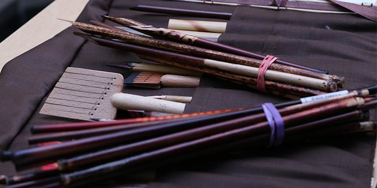 Calligraphy tools and brushes in felt holders